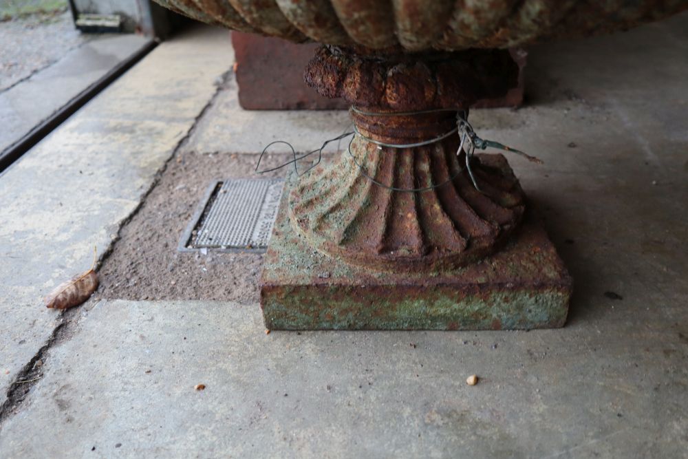A Victorian cast iron campana garden urn on plinth, 52cm diameter, height 34cm